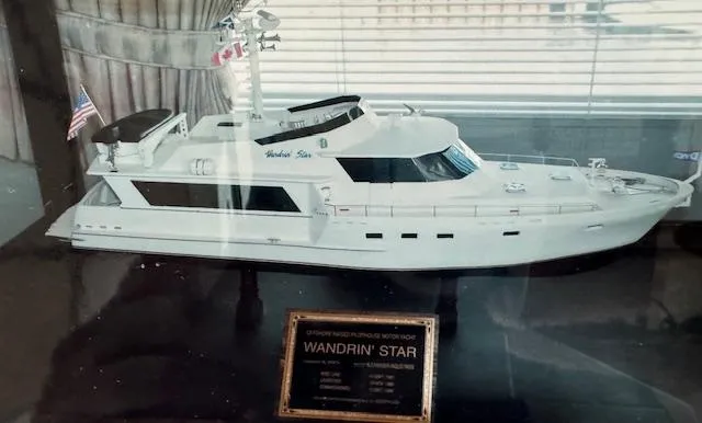 Slide: The Image of Model of 1990 Motor Yacht 70 Brata, named "Wandrin' Star," displayed in a glass case. - 8