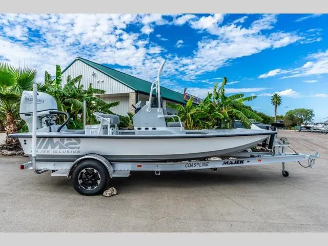 Slide: The Image of 2024 Majek Boats 18 M2 ILLUSION on trailer, parked outdoors under a blue sky. - 1