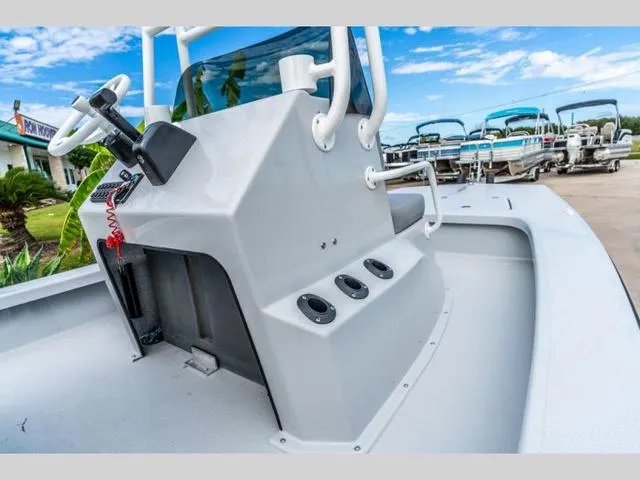 Slide: The Image of 2024 Majek Boats 18 M2 ILLUSION console, sleek design, outdoor display, clear blue sky. - 10