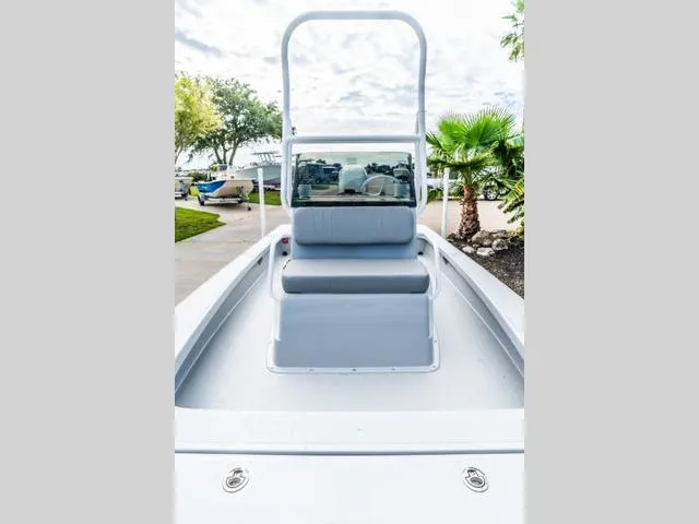 Slide: The Image of 2024 Majek Boats 18 M2 ILLUSION, sleek deck view with seating and lush surroundings. - 13