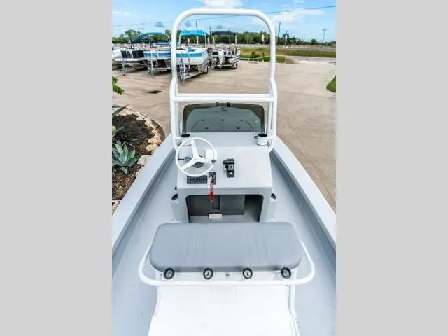 Slide: The Image of 2024 Majek Boats 18 M2 ILLUSION, center console view, sleek design, outdoor setting. - 2