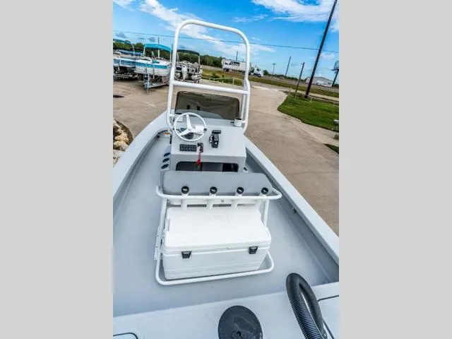 Slide: The Image of 2024 Majek Boats 18 M2 ILLUSION, center console view, white interior, outdoor setting. - 6