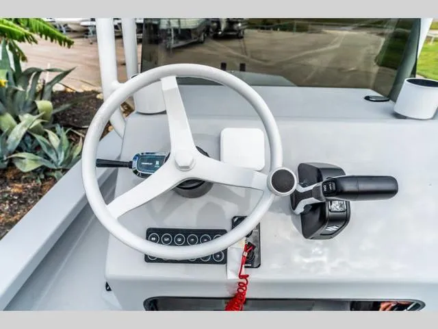Slide: The Image of 2024 Majek Boats 18 M2 ILLUSION steering console with controls and steering wheel. - 8