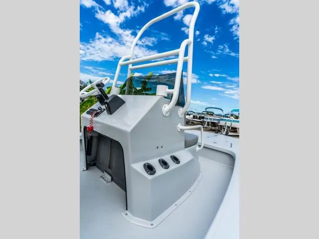 Slide: The Image of 2024 Majek Boats 18 M2 ILLUSION console with steering wheel, under a clear blue sky. - 9