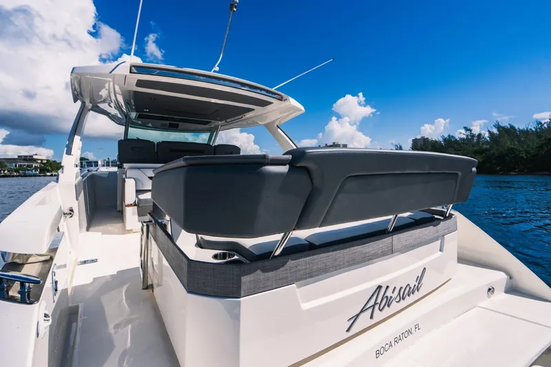 Slide: The Image of 2021 Tiara Sport 43 LS luxury boat on water, rear view, sunny day. - 15