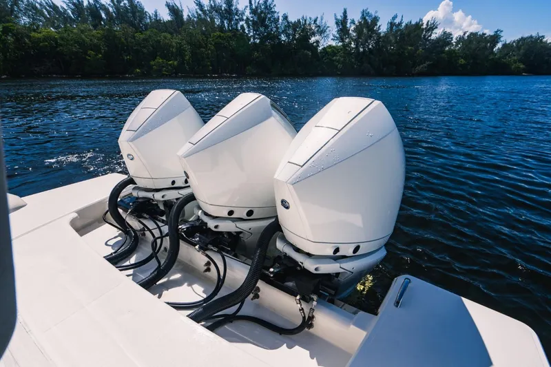 Slide: The Image of Triple outboard engines on a 2021 Tiara Sport 43 LS boat. - 16