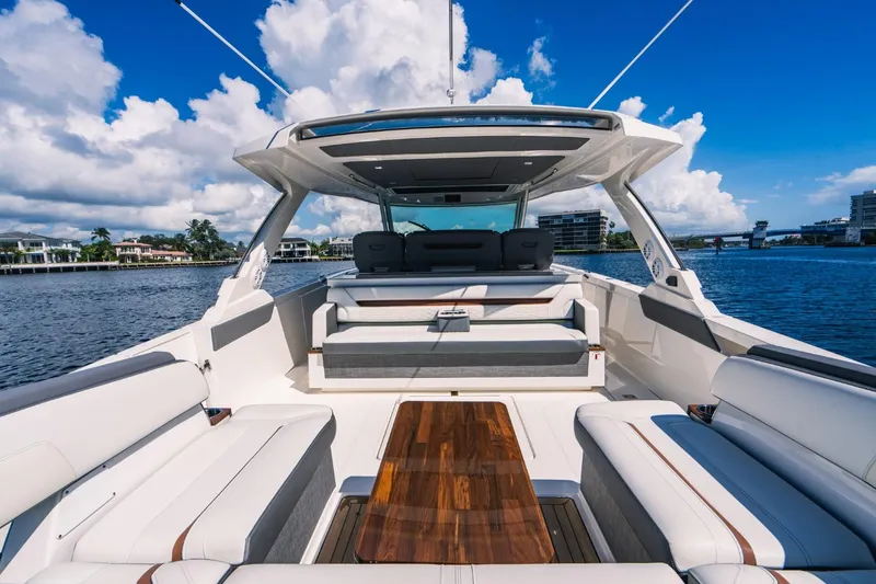 Slide: The Image of 2021 Tiara Sport 43 LS luxury yacht with spacious seating and wooden deck. - 20