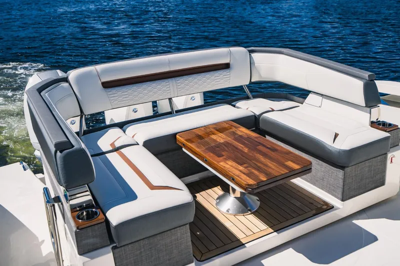 Slide: The Image of Luxury seating area on 2021 Tiara Sport 43 LS boat with wooden table. - 22