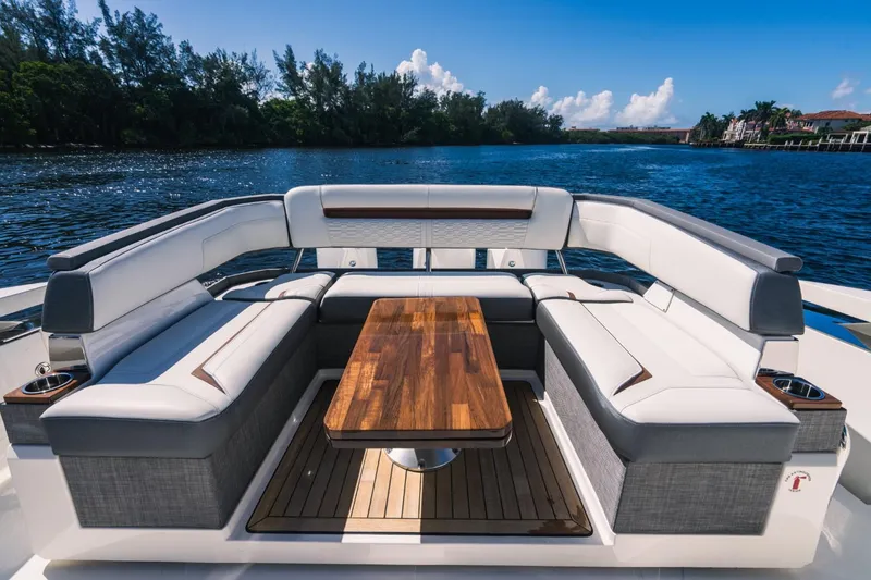 Slide: The Image of 2021 Tiara Sport 43 LS luxury yacht seating area with wooden table. - 23