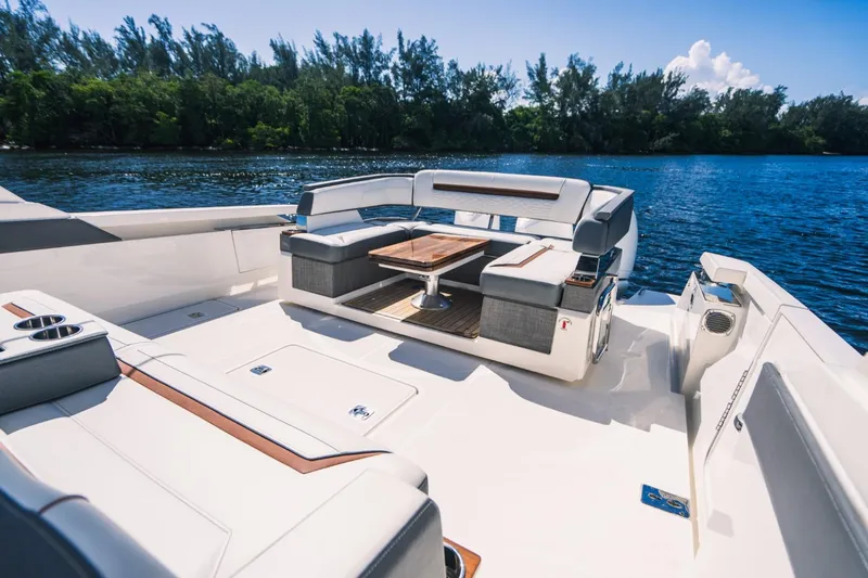 Slide: The Image of 2021 Tiara Sport 43 LS luxury boat with spacious seating and table on deck. - 24