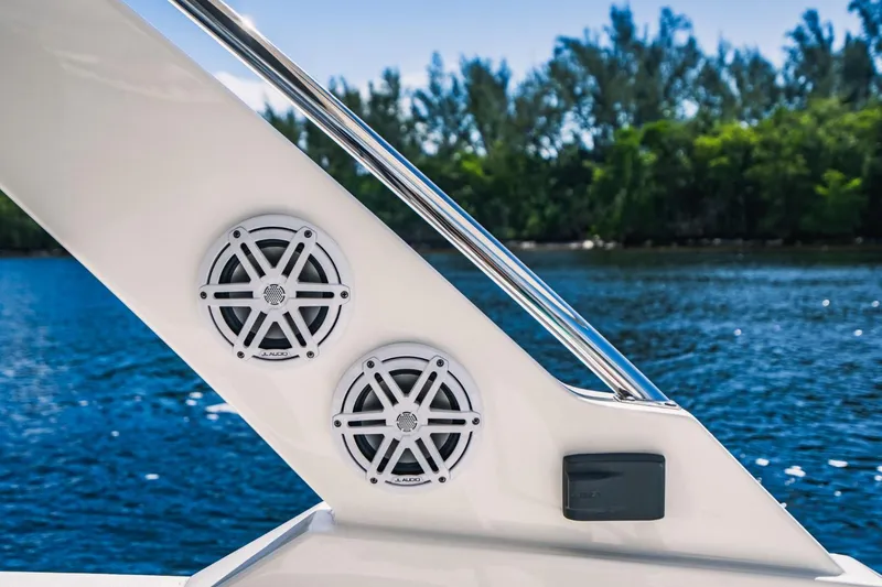 Slide: The Image of 2021 Tiara Sport 43 LS boat speakers and railing with water and trees in the background. - 25