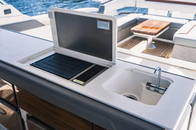 Slide: The Image of Outdoor kitchen area on a 2021 Tiara Sport 43 LS yacht with sink and grill. - 27