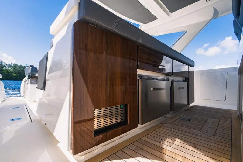 Slide: The Image of 2021 Tiara Sport 43 LS yacht with sleek outdoor kitchen and wooden cabinetry. - 29