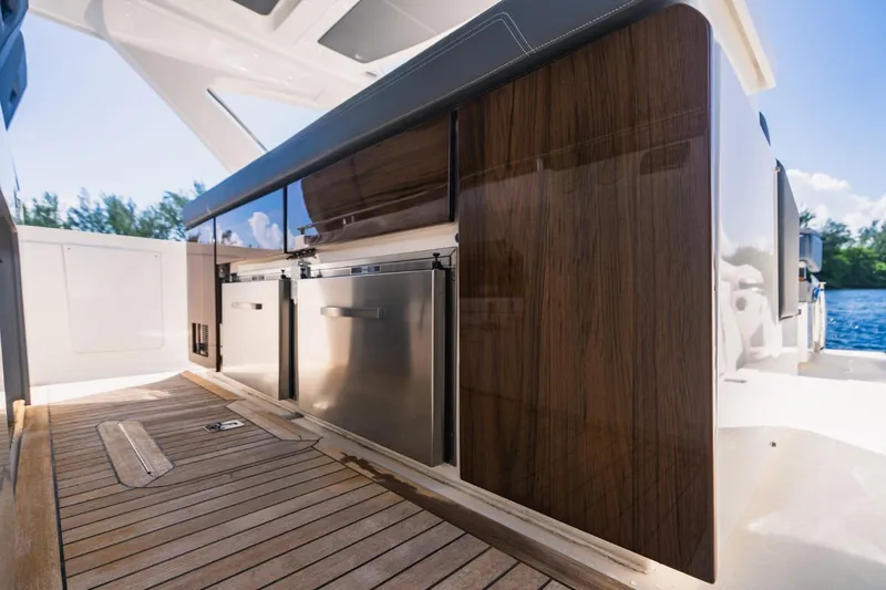 Slide: The Image of 2021 Tiara Sport 43 LS yacht interior with wooden cabinetry and stainless steel appliances. - 31