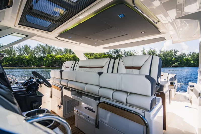 Slide: The Image of Interior of 2021 Tiara Sport 43 LS luxury boat with white seating and scenic water view. - 36