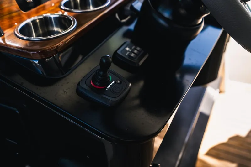 Slide: The Image of Control panel of 2021 Tiara Sport 43 LS boat with joystick and cup holders. - 46