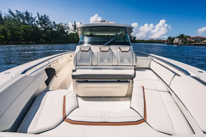 Slide: The Image of 2021 Tiara Sport 43 LS luxury boat with white leather seating on a sunny day. - 48