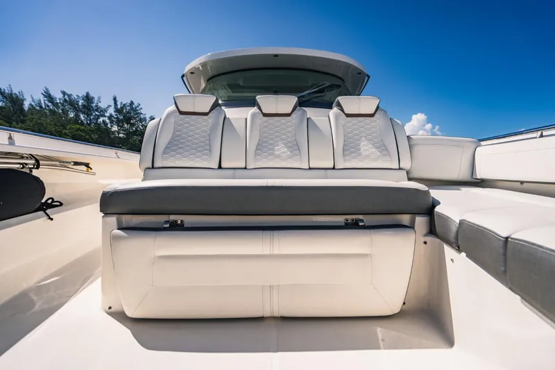 Slide: The Image of 2021 Tiara Sport 43 LS luxury boat seating area under clear blue sky. - 49