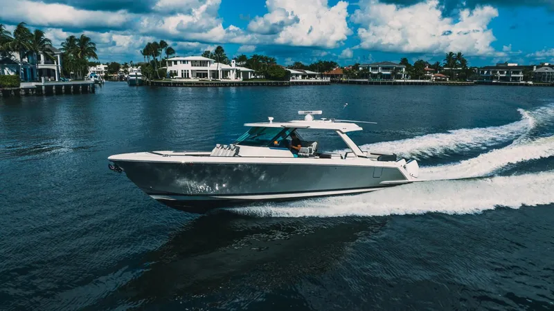 Slide: The Image of 2021 Tiara Sport 43 LS cruising on a scenic waterway. - 6