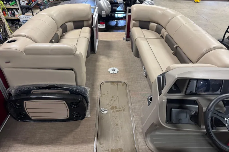 Slide: The Image of 2024 Sun Tracker Party Barge 22 XP3 interior with beige seating and steering console. - 15