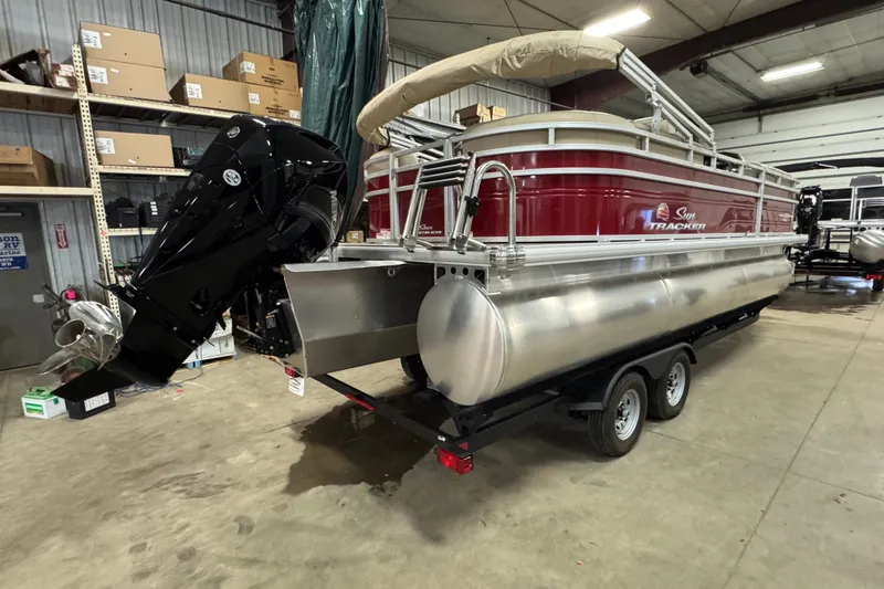 Slide: The Image of 2024 Sun Tracker Party Barge 22 XP3 pontoon boat in a warehouse setting. - 17