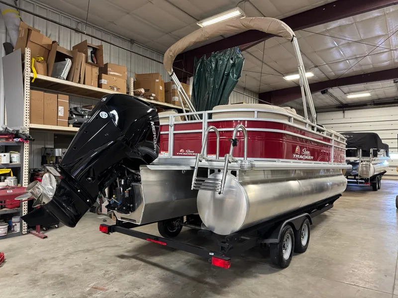 Slide: The Image of 2024 Sun Tracker Party Barge 22 XP3 pontoon boat in a storage facility. - 2