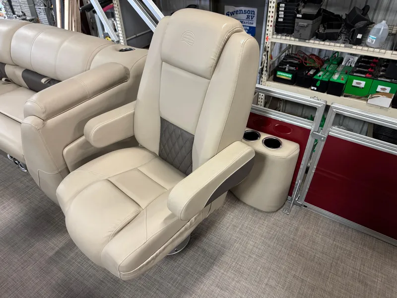 Slide: The Image of 2024 Sun Tracker Party Barge 22 XP3 captain's chair with beige upholstery and cup holders. - 8