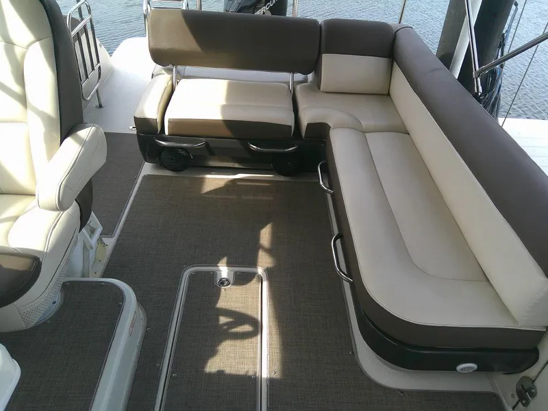 Slide: The Image of 2022 Bayliner Element XR7 boat interior with beige and brown seating. - 11