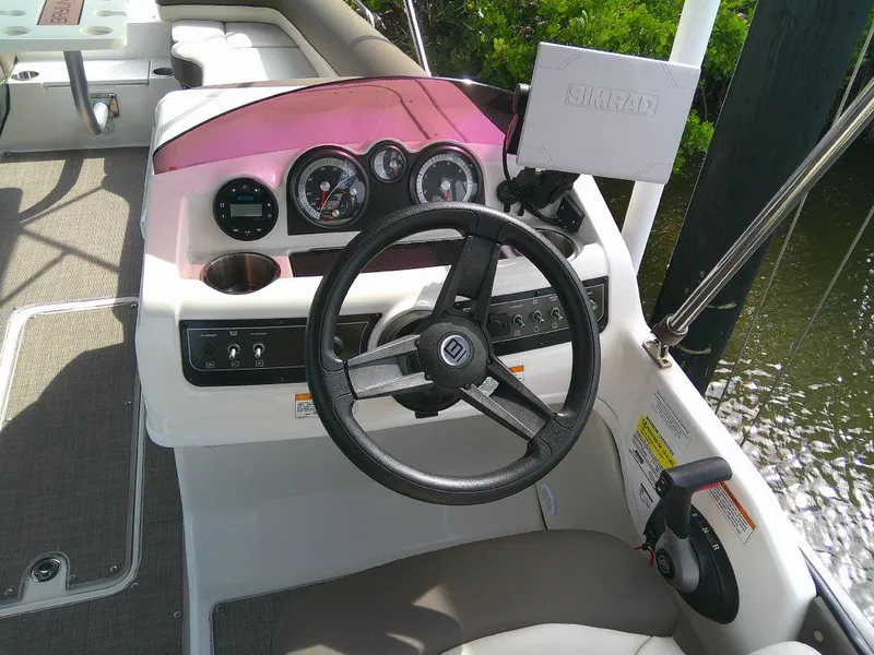 Slide: The Image of 2022 Bayliner Element XR7 boat dashboard with steering wheel and control panel. - 7