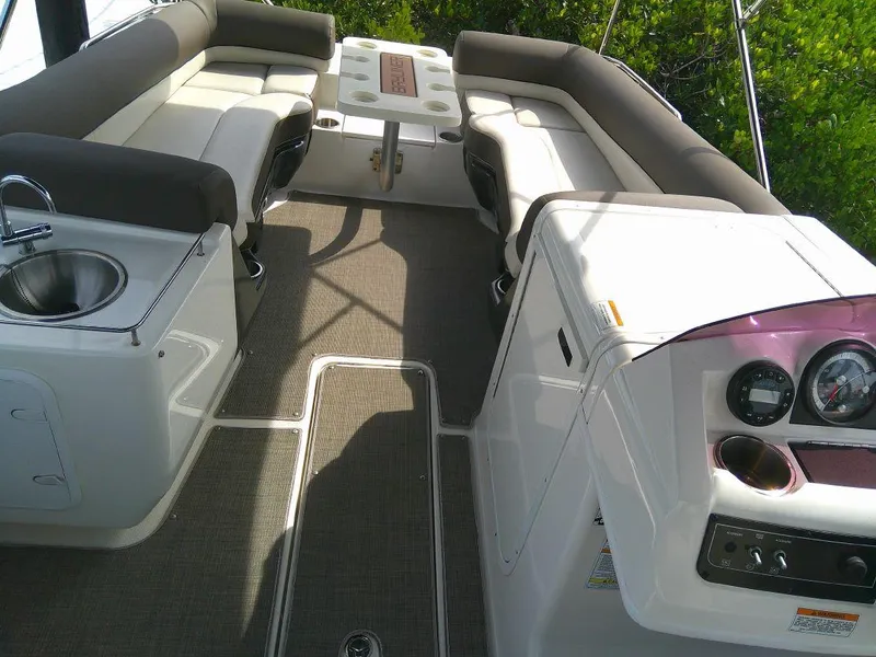 Slide: The Image of Interior of a 2022 Bayliner Element XR7 boat with seating and a small sink. - 8