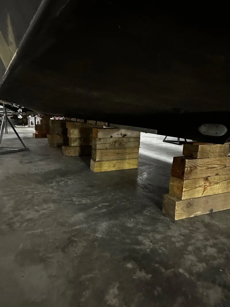 Slide: The Image of 1975 Marinette 32' Cruiser on wooden blocks in a garage. - 11