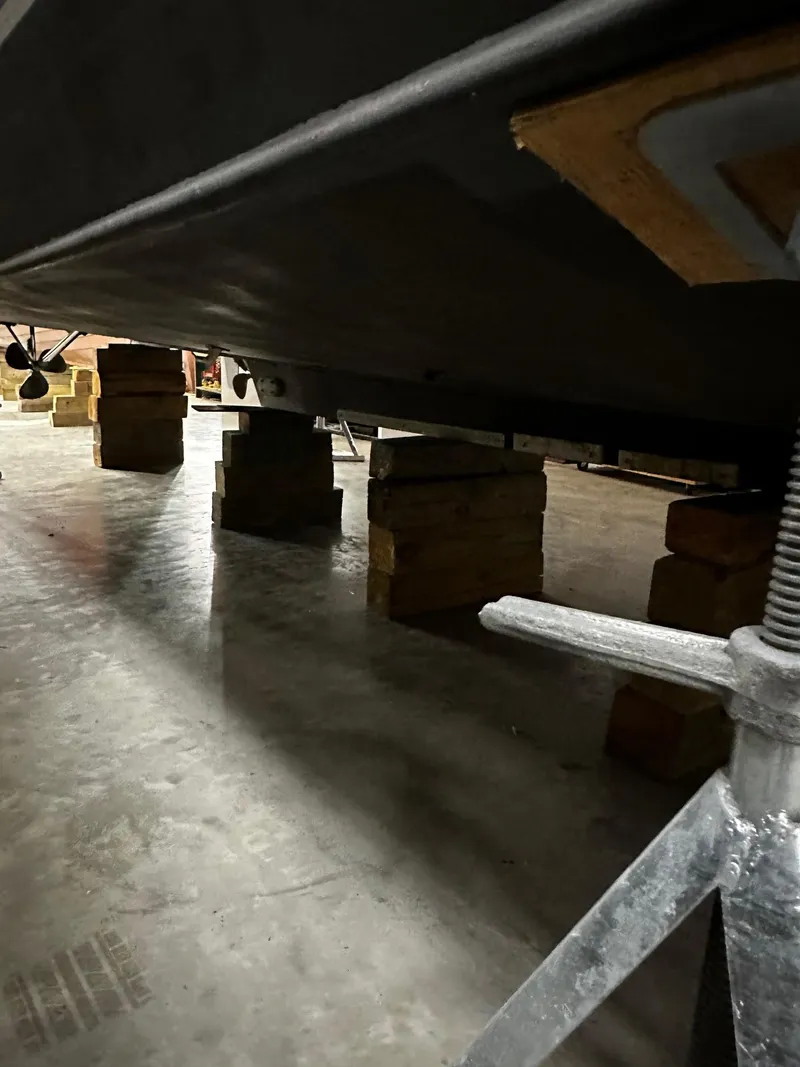 Slide: The Image of 1975 Marinette 32' Cruiser on blocks in a storage facility. - 12