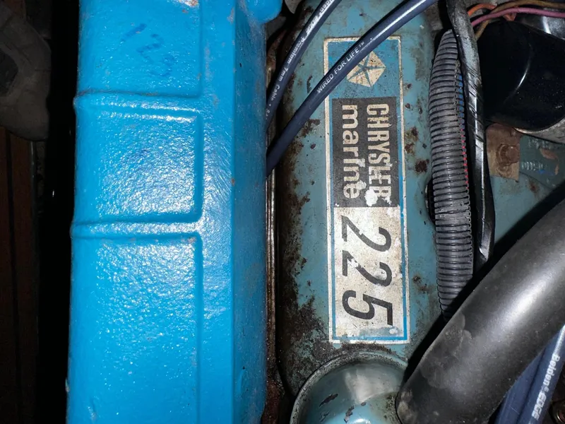 Slide: The Image of Chrysler Marine 225 engine in a 1975 Marinette 32' Cruiser, blue components visible. - 15