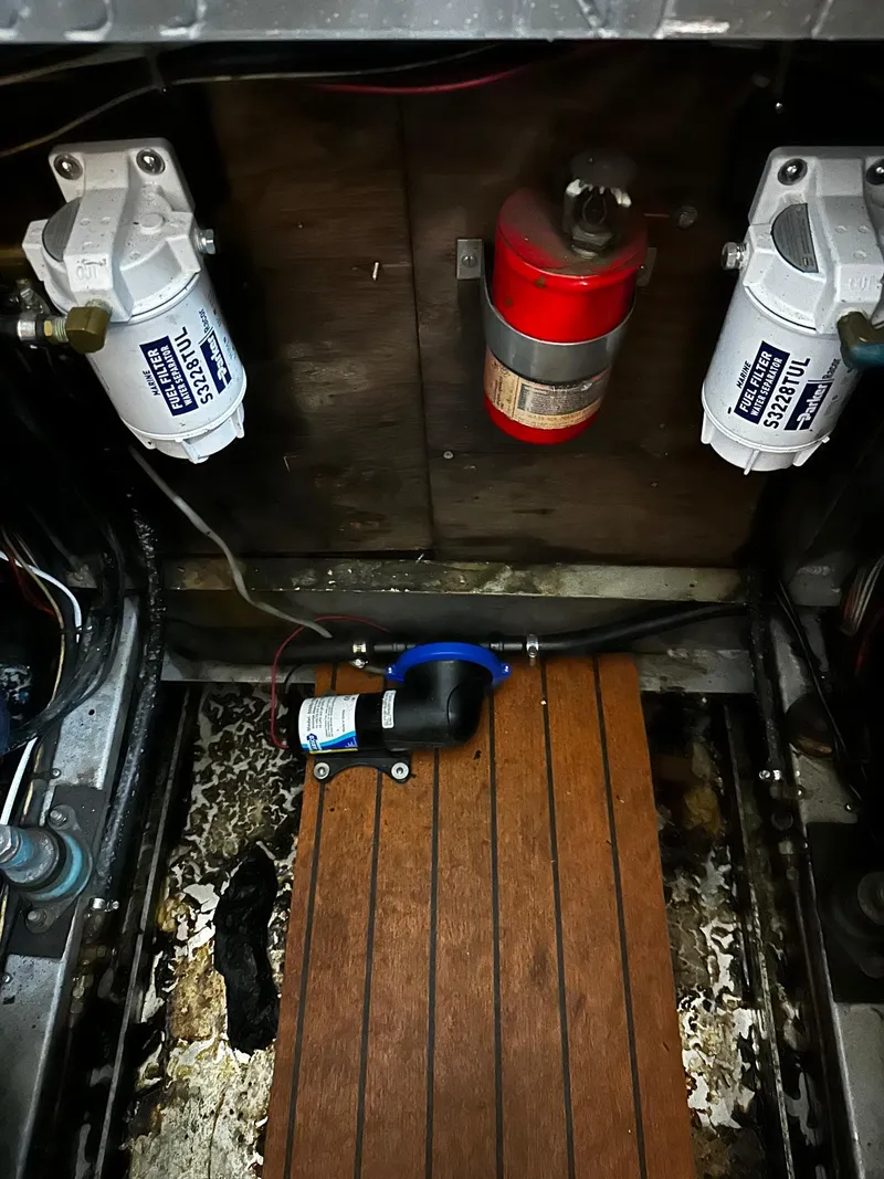 Slide: The Image of Engine compartment of a 1975 Marinette 32' Cruiser with filters and fire extinguisher. - 18