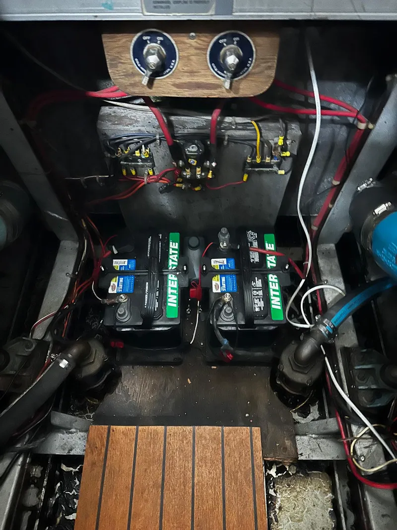Slide: The Image of Engine compartment of a 1975 Marinette 32' Cruiser with batteries and wiring. - 19