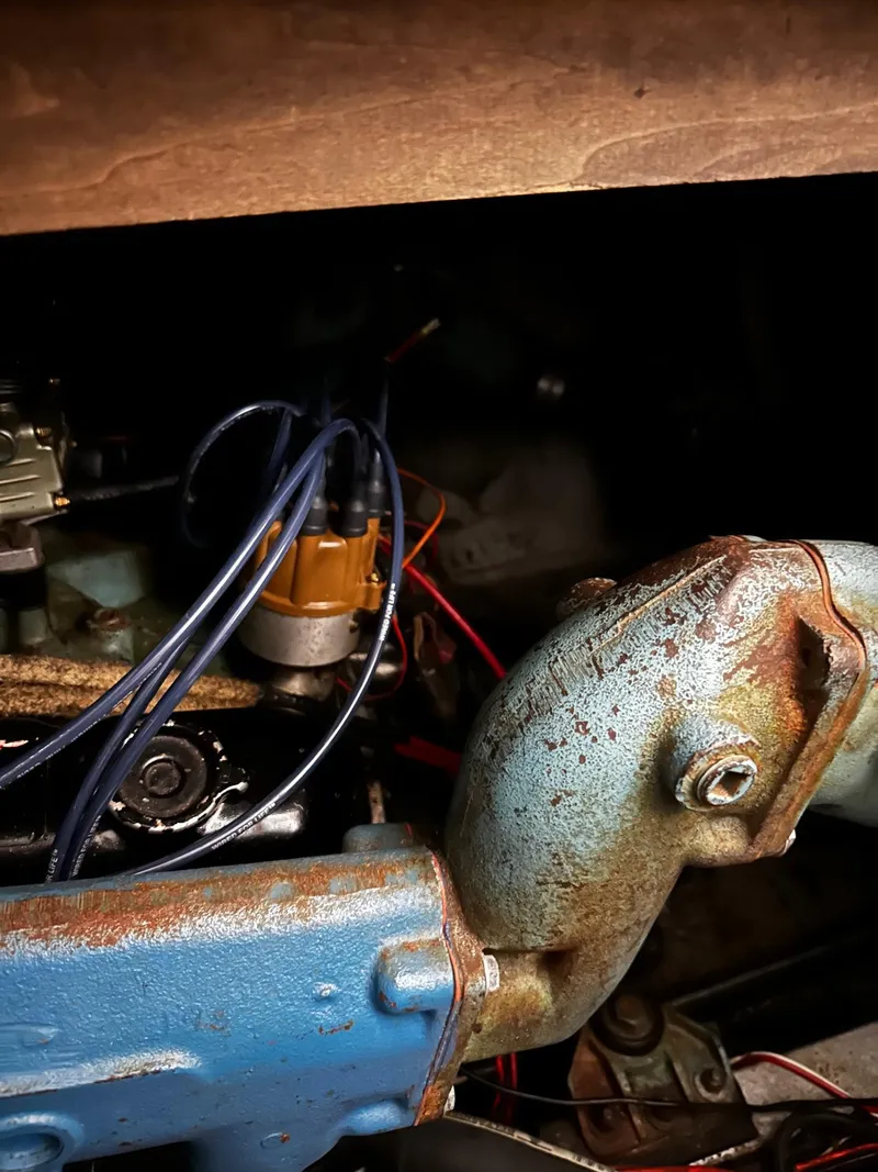 Slide: The Image of Engine components of a 1975 Marinette 32' Cruiser with visible wiring and rust. - 20