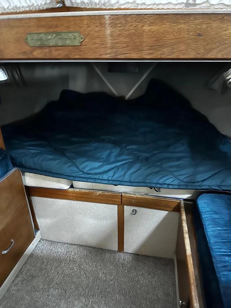 Slide: The Image of 1975 Marinette 32' Cruiser cabin interior with cozy sleeping area and wooden storage. - 24