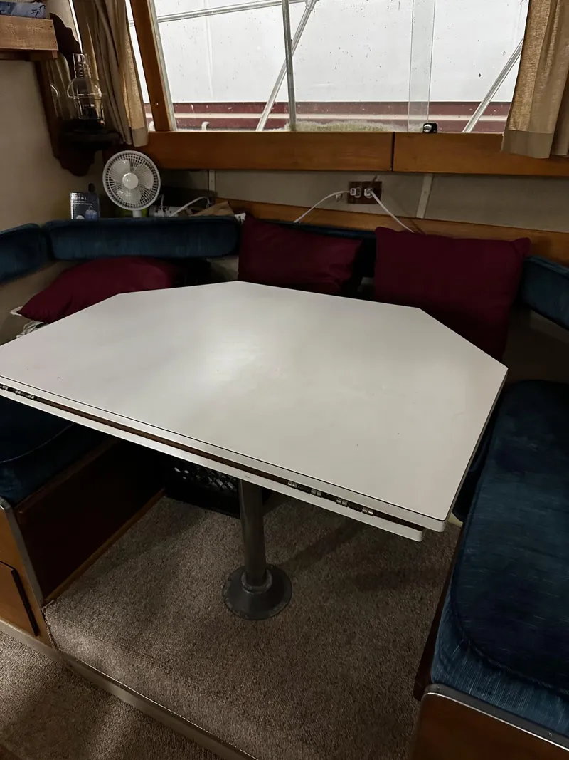 Slide: The Image of 1975 Marinette 32' Cruiser interior with white table and blue seating. - 25