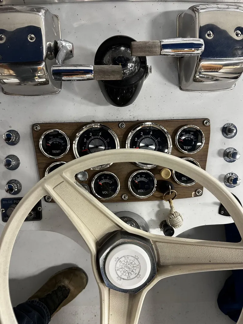Slide: The Image of 1975 Marinette 32' Cruiser dashboard with steering wheel and control gauges. - 30
