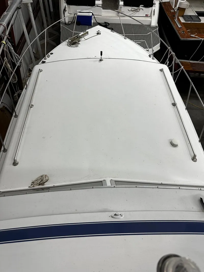 Slide: The Image of 1975 Marinette 32' Cruiser boat deck, white surface, docked in marina. - 31