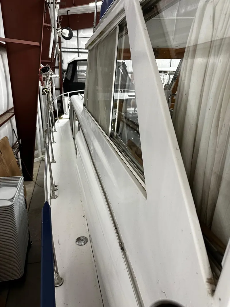 Slide: The Image of 1975 Marinette 32' Cruiser in storage, showcasing side view and windows. - 32
