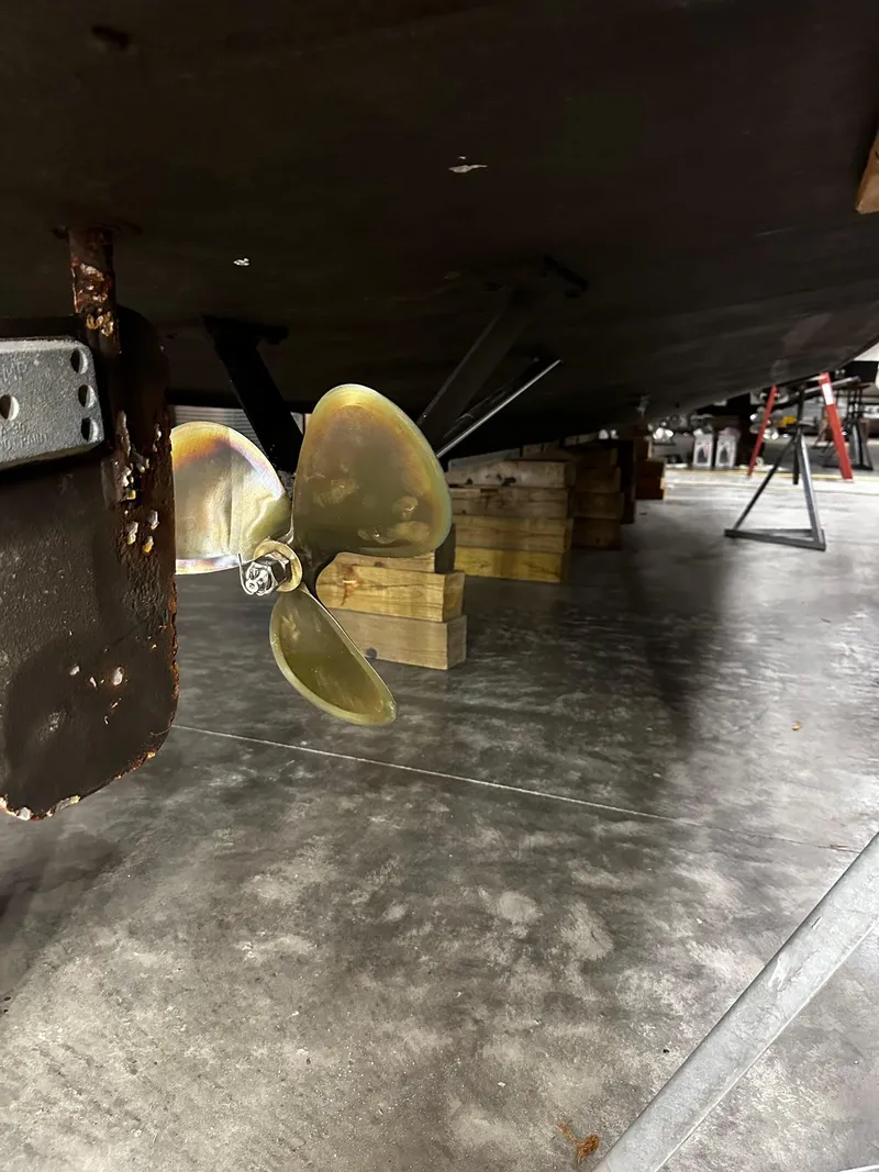 Slide: The Image of Propeller of 1975 Marinette 32' Cruiser on dry dock, supported by wooden blocks. - 9