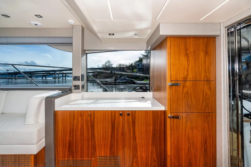 Slide: The Image of Interior of 2017 Sunseeker Manhattan 52 yacht with wooden cabinetry and waterfront view. - 15