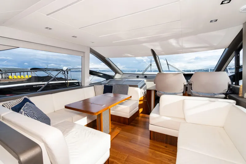 Slide: The Image of Luxurious interior of 2017 Sunseeker Manhattan 52 yacht with white seating and wooden table. - 17