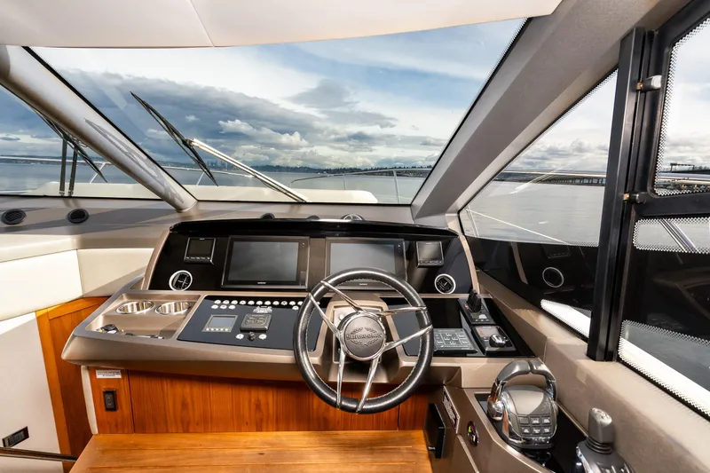 Slide: The Image of 2017 Sunseeker Manhattan 52 yacht helm with modern navigation equipment and panoramic sea view. - 21