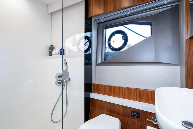 Slide: The Image of Modern bathroom on 2017 Sunseeker Manhattan 52 yacht with shower and porthole window. - 35