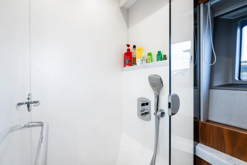 Slide: The Image of Modern shower area in 2017 Sunseeker Manhattan 52 yacht with toiletries and window. - 40
