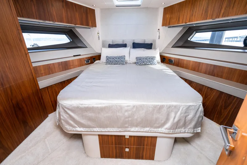 Slide: The Image of Luxurious bedroom in 2017 Sunseeker Manhattan 52 yacht with modern wood paneling. - 44