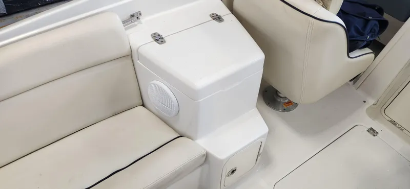 Slide: The Image of 2004 Chris-Craft Corsair 25 interior seating and storage compartment. - 12