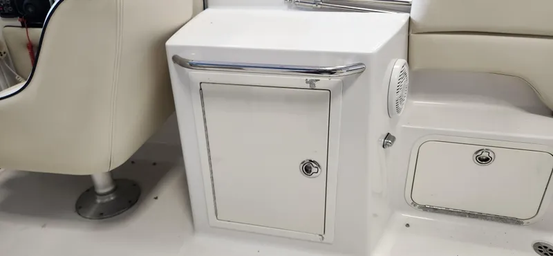 Slide: The Image of 2004 Chris-Craft Corsair 25 interior storage compartments and seating. - 14